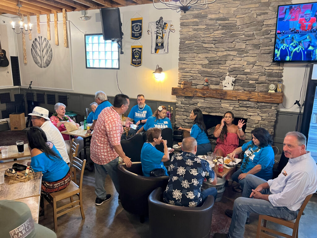 A family reunion gathered by the fireplace at Project Barley Square